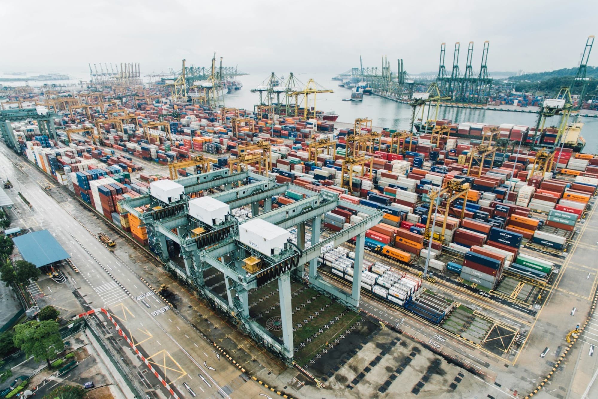 Container terminal seen from above, with gantry cranes working a berth